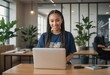 © natakot - A woman with braided hair is using a laptop in an office. She appears content and professional.