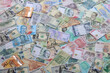 © mehaniq41 - Many banknotes of different currency. Background of big amount of random money bills close up