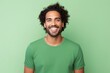 Portrait of smiling african american man in green t-shirt on green background
