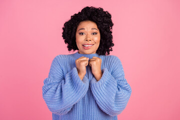 Wall Mural - Photo portrait of lovely young lady fists cute shy pose hope bite lips wear trendy blue knitted garment isolated on pink color background