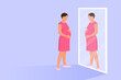 Pregnant woman looking at herself in the mirror
