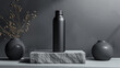 Matte black stainless steel water bottle standing tall on a matte gray base.