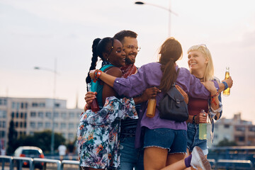 Wall Mural - Cheerful friends gathering on street while going to summer music festival.