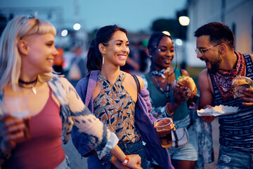 Wall Mural - Happy woman having fun with friends during open air music festival in summer.