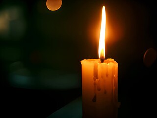 Wall Mural - a lit candle with a blurry background