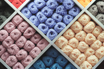 Aufkleber - Multi-colored skeins of wool on display in a store as a background