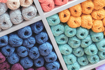 Aufkleber - Multi-colored skeins of wool on display in a store as a background
