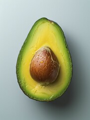 Wall Mural - A halved ripe avocado sits alone against a white backdrop, showcasing its freshness and vibrant green color.