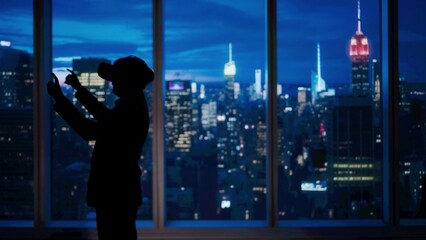 Successful business man in the office. Man ceo hedge fund top manager in vr glasses playing video game in front of window with evening city view.