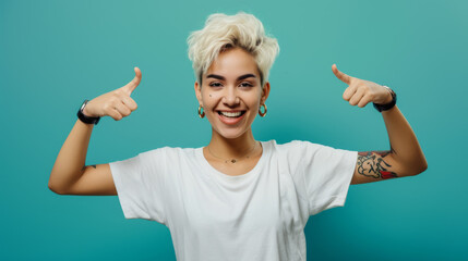 Sticker - cheerful young woman with short blonde hair and tattoos is pointing to both sides with a big smile, against a vibrant turquoise background