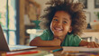 © VLA Studio - a child with curly hair, joyfully laughing while engaged in drawing or coloring, sitting at a table with papers and coloring materials.