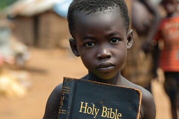 Wall Mural - Poor young african kid with Bible.	