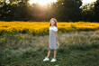 © Maria Manco/Stocksy - Preteen smiles at camera in wildflower field