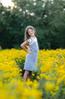 © Maria Manco/Stocksy - Preteen smiles at camera in wildflower field