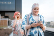 © Santi Nuñez/Stocksy - Muslim women using phone