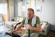 © Marko Geber - Tired middle aged man working out at home on fitness bike