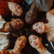 Happy multi ethnic group of friends lying down on the floor and looking up 