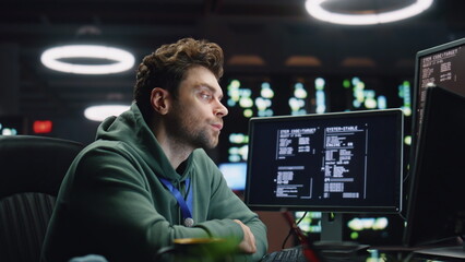 Overworked programer looking monitor working late in office closeup. Man typing
