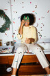 © BONNINSTUDIO/Stocksy - Confetti falls on woman at a christmas party Ugc