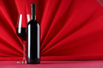 Sticker - Stylish presentation of delicious red wine in bottle and glass on color background. Space for text