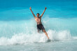 © Sonja Lekovic/Stocksy - Man jumping into a turquoise sea wave splash