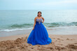 © Jimena Roquero/Stocksy - Latina girl in Quinceañera gown posing in the beach
