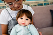 © Maria Manco/Stocksy - little girl holds baby doll