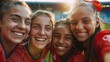 Group of young female soccer players celebrating victory, close up 
