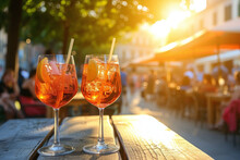 Two Glasses Of Aperol Spritz Cocktails On The Table In Italian Restaurant, Street View