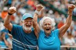 A couple of older people are smiling and holding hands while standing in a crowd. The man is wearing a blue shirt with stripes and the woman is wearing a blue shirt. Tennis Roland Garros Concept