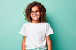 © Iryna - Young girl in glasses and white shirt on mint green wall background. T-shirt mockup.