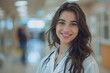 © Prasanth - smiling girl doctor in white doctor robe on a blurred background in the hospital hall