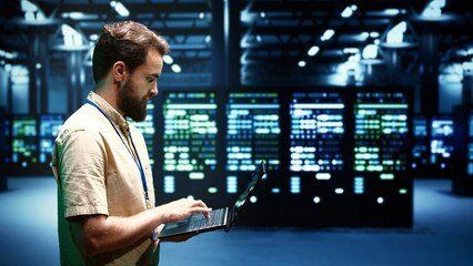 Developer checking event logs and diagnostic tools to identify server issues root cause. Programmer using laptop to check supercomputer operating system configuration settings