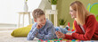 © Pixel-Shot - Female psychologist working with boy suffering from autistic disorder