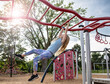© Bethany Birnie/Stocksy - Swinging on the monkeybars
