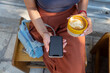 © Branislava Zivic Zrnic/Stocksy - Female drinking coffe and looking at her mobile phone