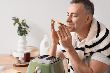 Sticker - Middle-aged man with crispy toasts in kitchen