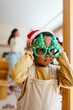 © BONNINSTUDIO/Stocksy - Cute little boy in Santa hat and funny glasses