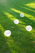 © Colour Laboratory/Stocksy - Clear plastic transparent balls in grass in garden with beam of light