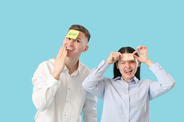 Poster - Business people with sticky papers on their foreheads against blue background. April Fools' Day celebration