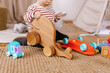 © Oleksii Syrotkin/Stocksy - Toddler toys play faceless alone bedroom cozy activity