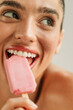 © Studio Firma/Stocksy - Portrait of young woman in studio eating ice cream