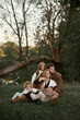 © Iuliia Versta/Stocksy - big family sitting in nature
