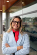 © Raymond Forbes LLC/Stocksy - LGBTQ Businesswoman Office portrait of happy transgender woman
