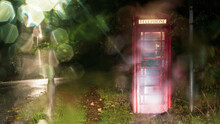 A Red Telephone Box At Night