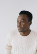 © Tanya Yatsenko/Stocksy - A portrait of a young man in a sweater indoors