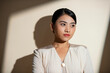 © Marc Tran/Stocksy - Asian business lady on white background