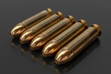 Fototapeta Na sufit - A row of five bullets are shown in a close up