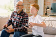 © DZ FILM/Stocksy - Grandfather and grandson play video games