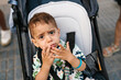 © Ezequiel Giménez/Stocksy - Toddler sitting in stroller